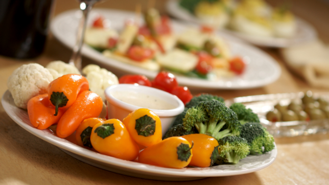 A platter of raw vegetables with mustard