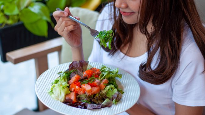 A woman eats a salad